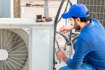 Davis Heating & Air Technician Installing Indoor Air Conditioning System