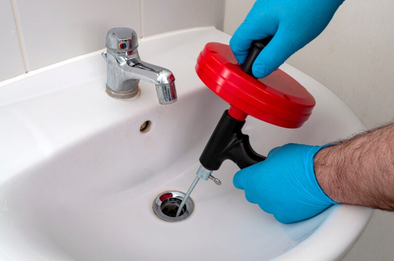 Davis plumber snaking clogged drain during drain cleaning service.
