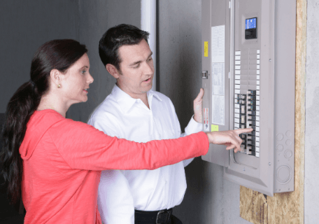Homeowner consulting with electrician about replacing electrical panel