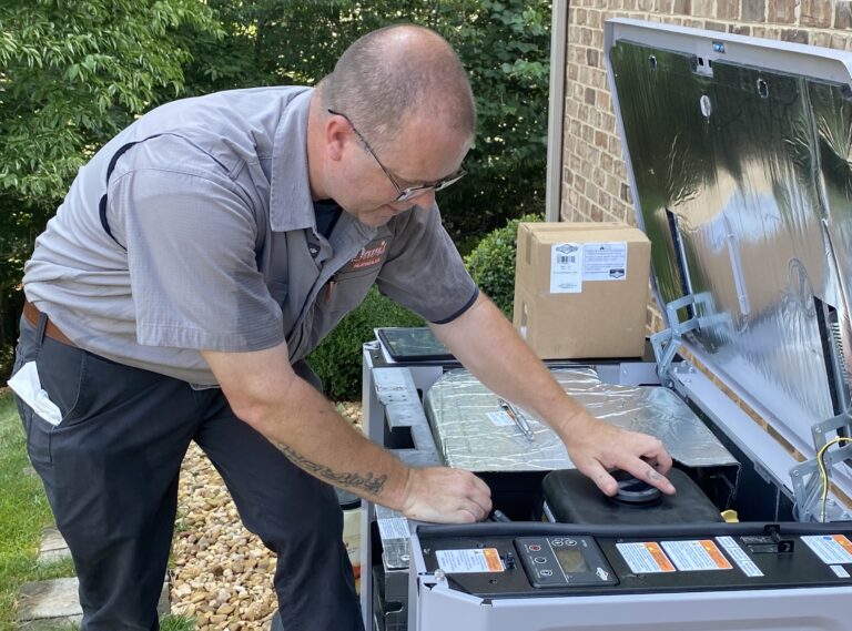 Davis technician inspecting generator for hurricane season.