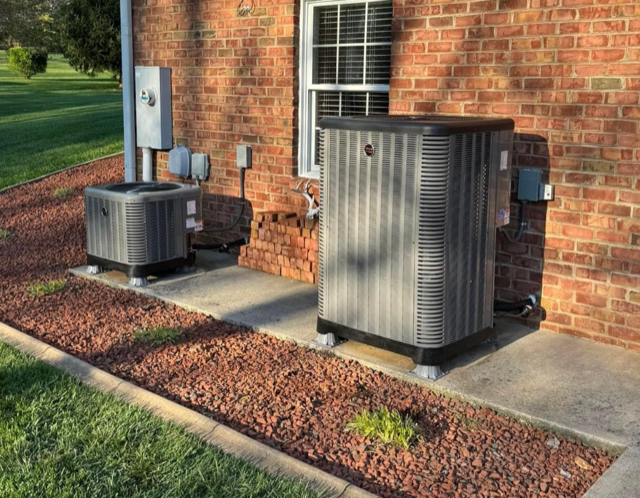 Two modern HVAC units outside of a residential home