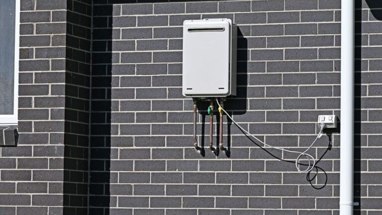 Tankless water heater mounted to a brick wall